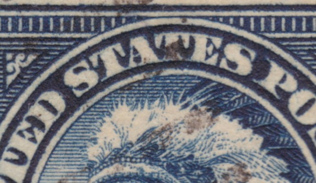 Detail of 14¢ American Indian stamp showing traces of possible double transfer in “UNITED STATES” lettering