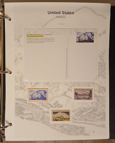 Album page with postal card and three stamps picturing Denali in Alaska